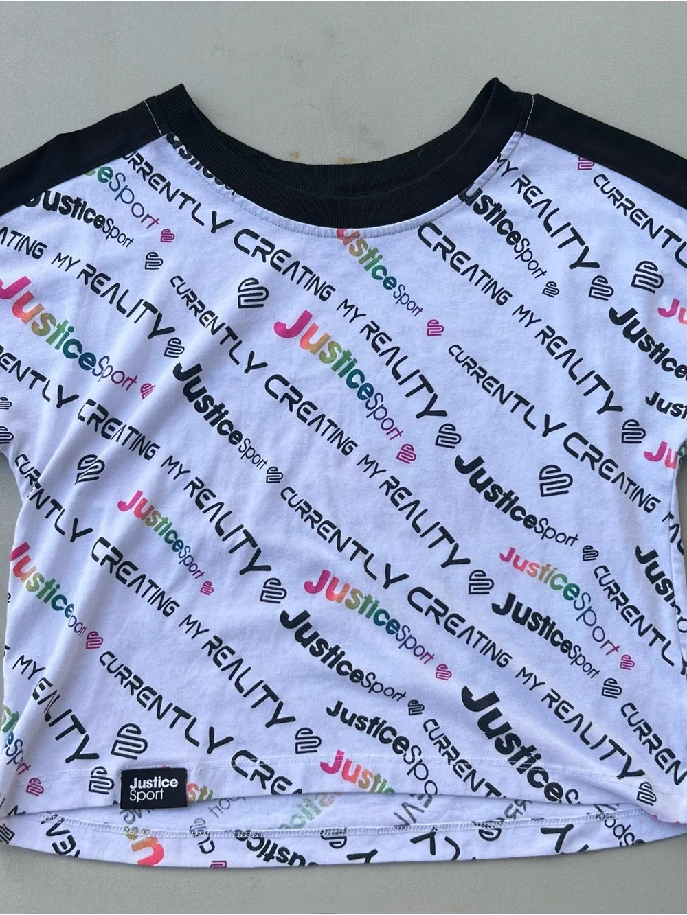 Justice White Tee with Black Trim and Multicolor Logo Print